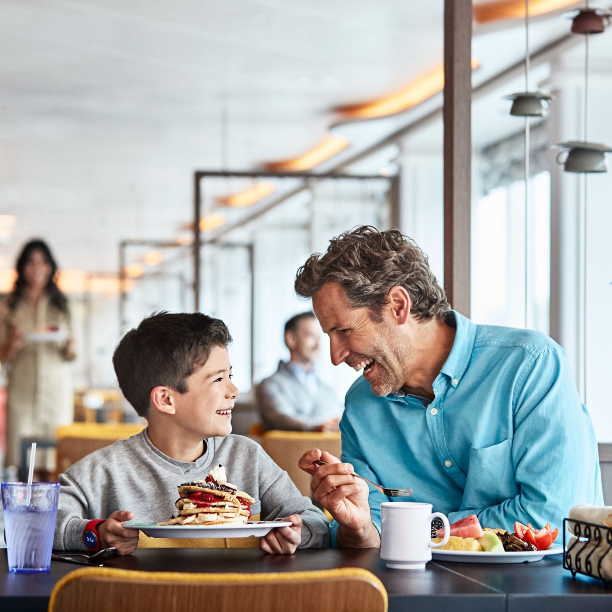 Father and son having breakfast, World Fresh Marketplace.